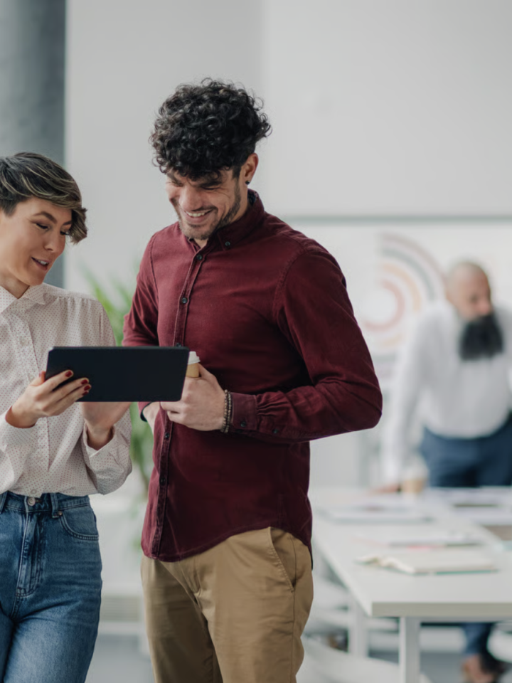 Two colleagues reviewing correspondence together on a tablet